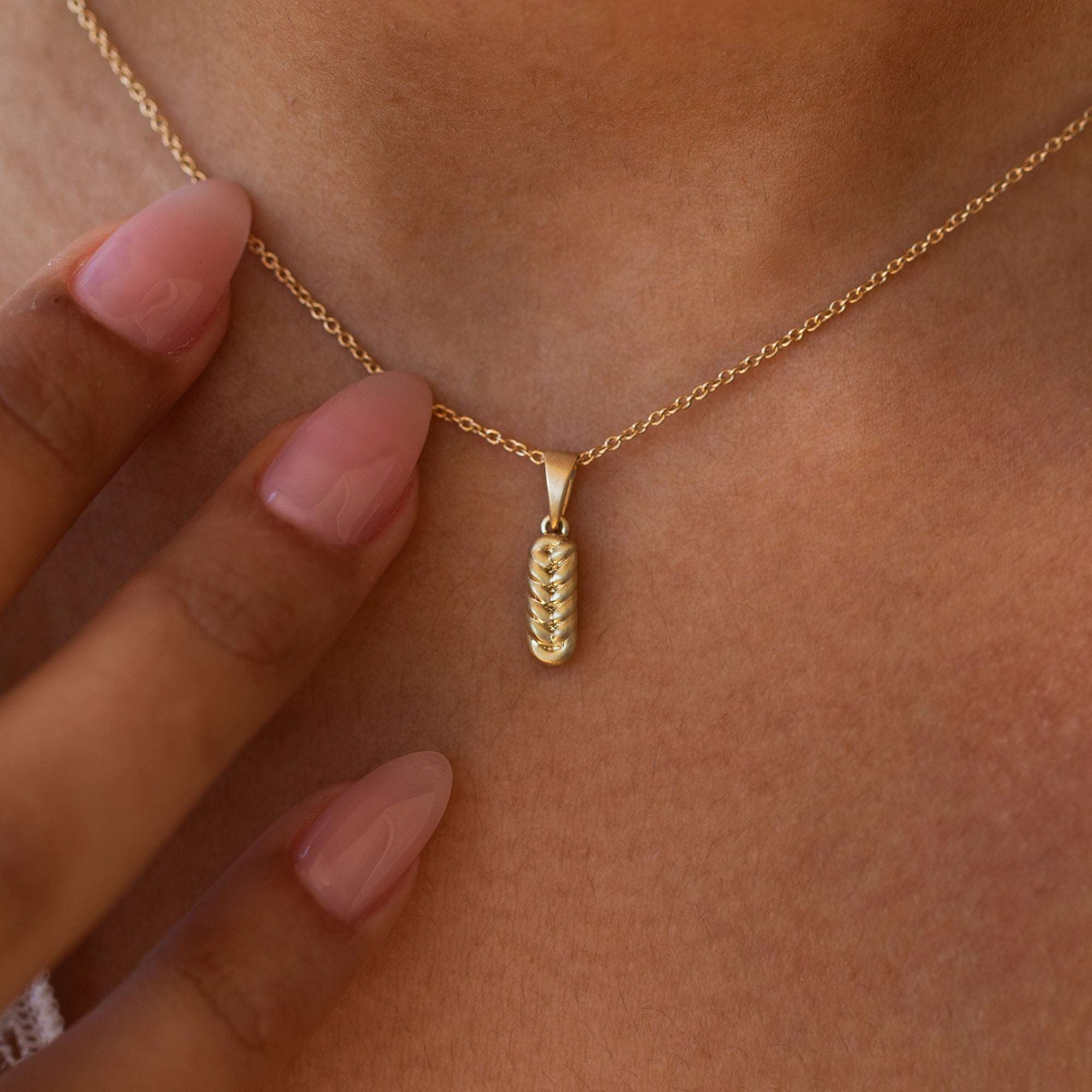 תקריב של שרשרת זהב לאישה עם תליון זהב