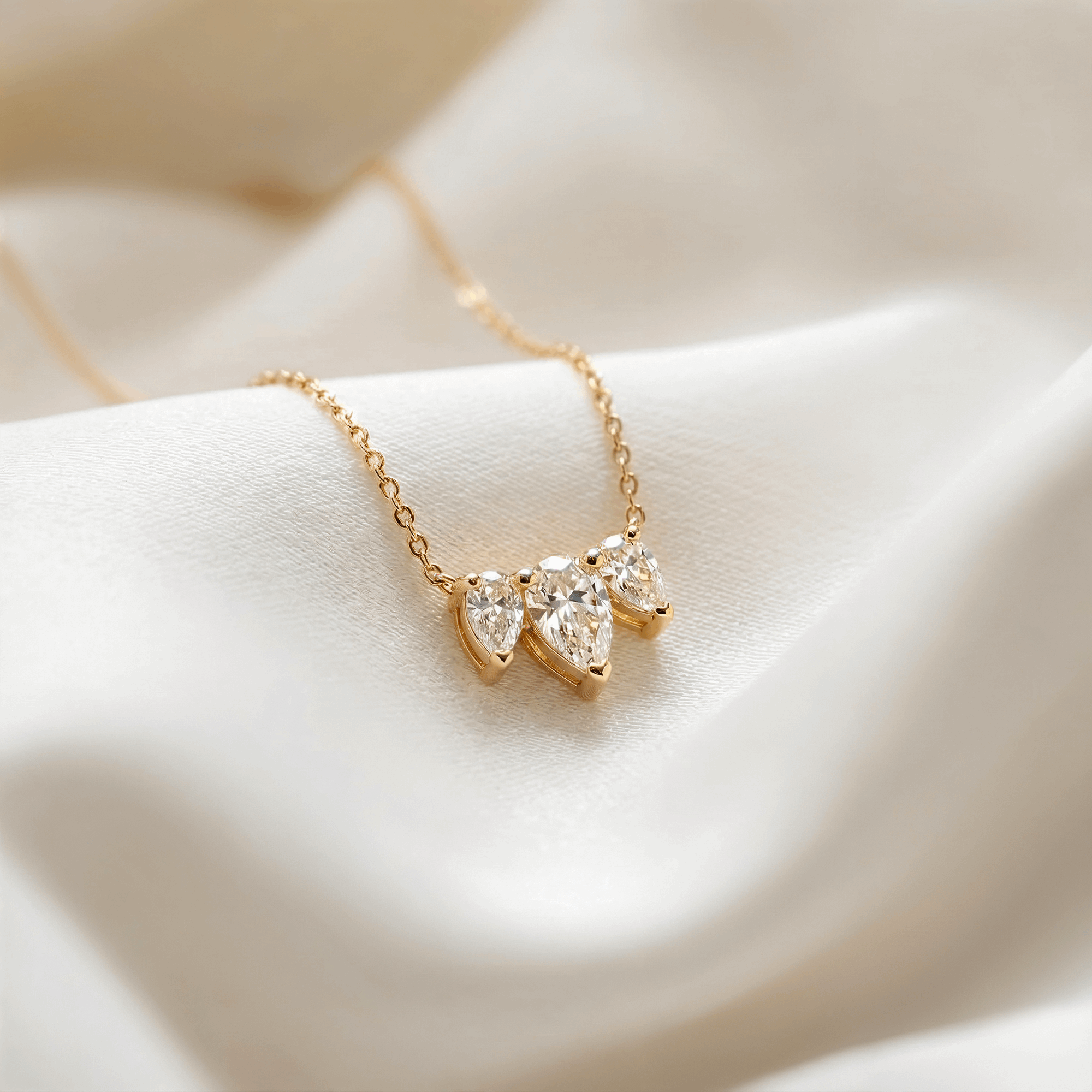 שרשרת יהלום טיפה בזהב צהוב על רקע בד לבן