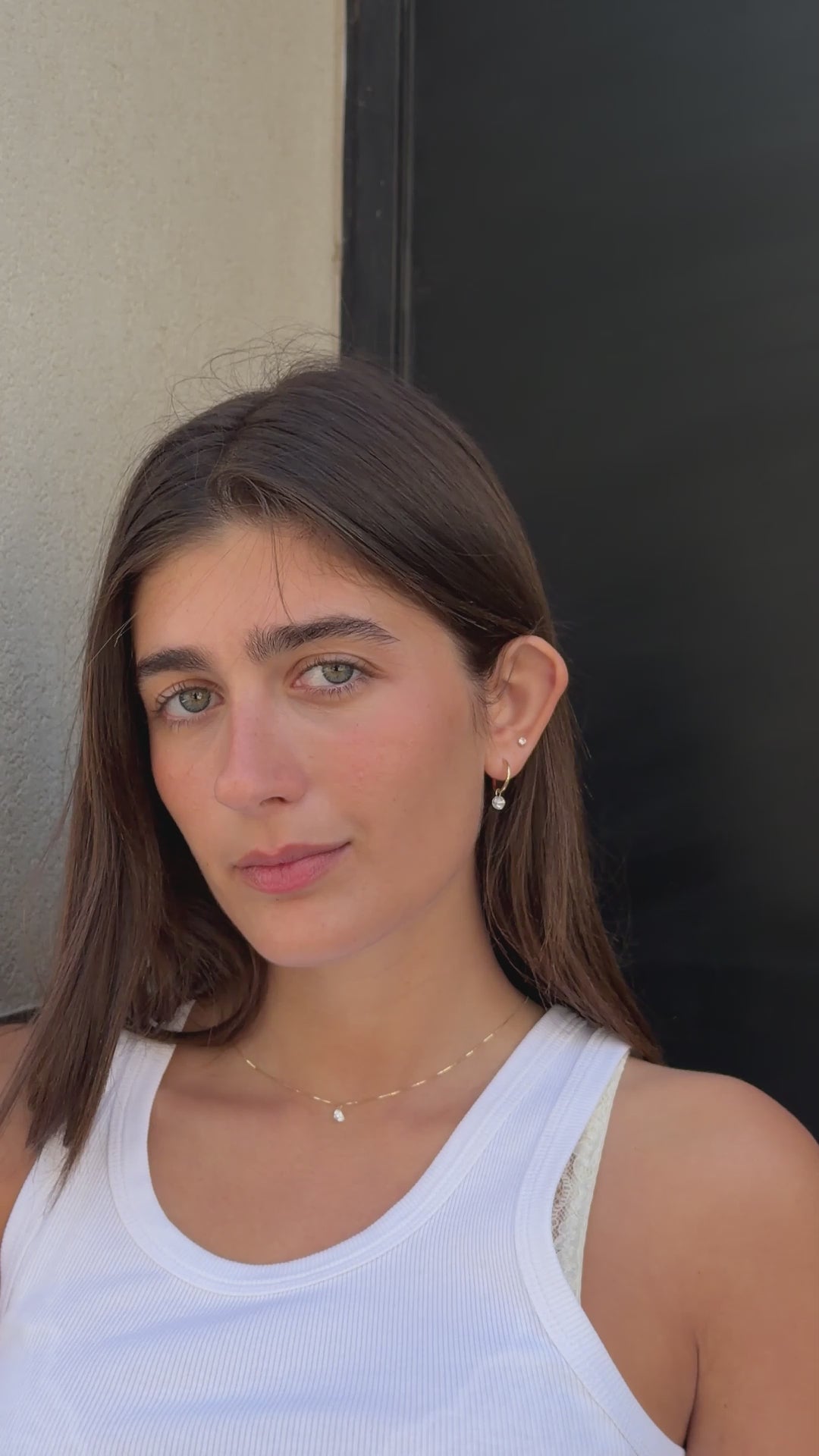 סרטון של דוגמנית עונדת שרשרת יהלום לב ולאחר מכן תקריב של תליון יהלום מרחף